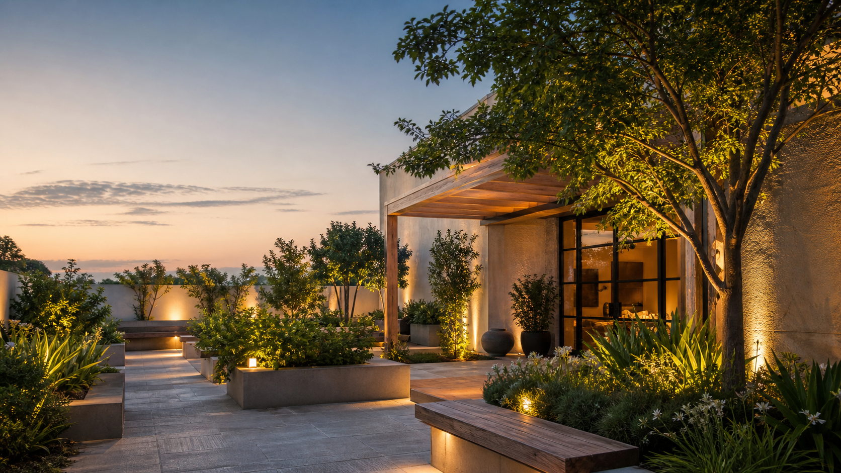 A warmly lit modern courtyard garden at dusk
